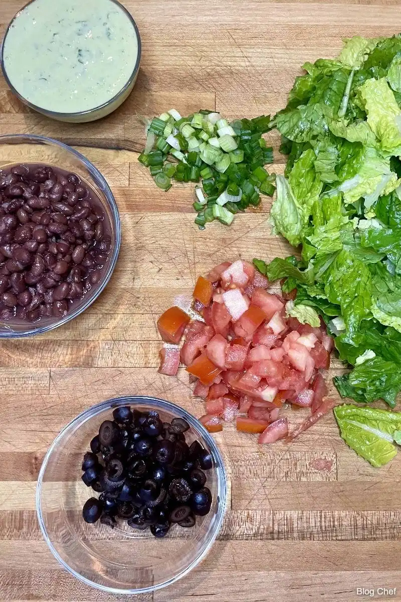 Main ingredients for chopped taco salad on cutting board. 